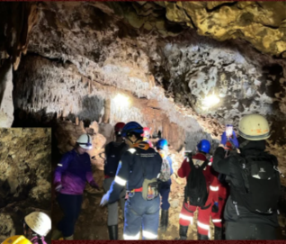 Participants moving through a cave during an expedition