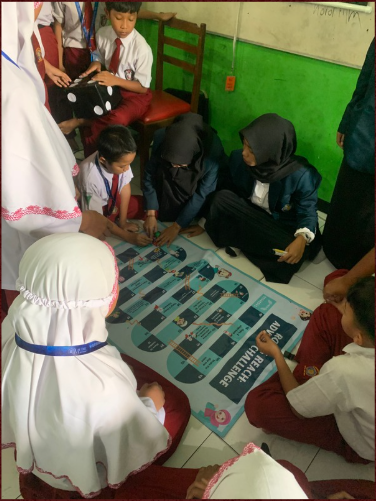 Young learners using an interactive English learning board designed by Dila